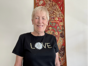 Woman with short blonde hair and black tshirt that says love