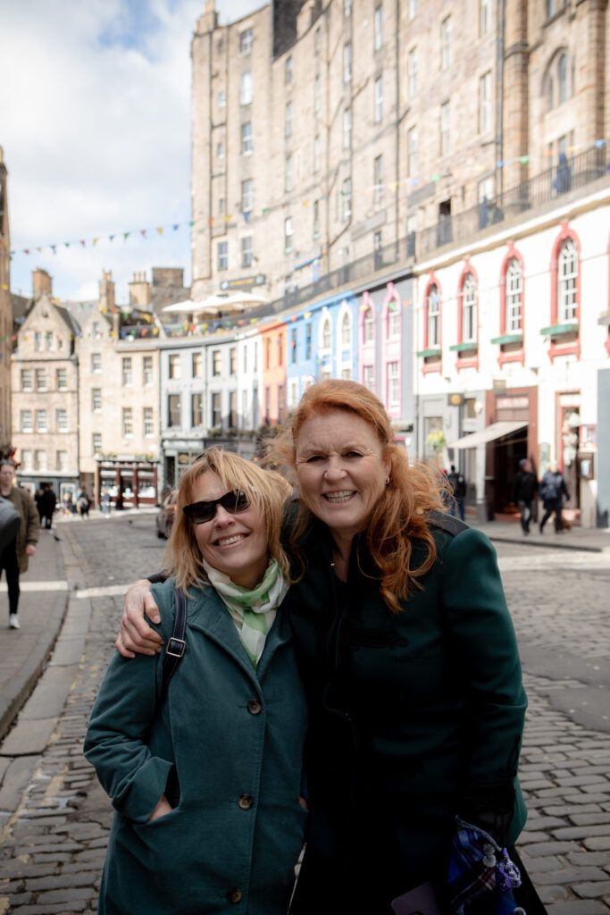 Marguerite Kaye and Sarah Ferguson standing together in English town on cobbled streets