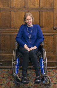 Claire wade, woman in blue top in wheelchair