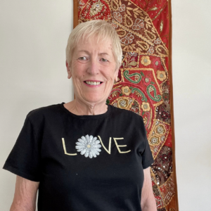 Woman with short blonde hair and black tshirt that says love